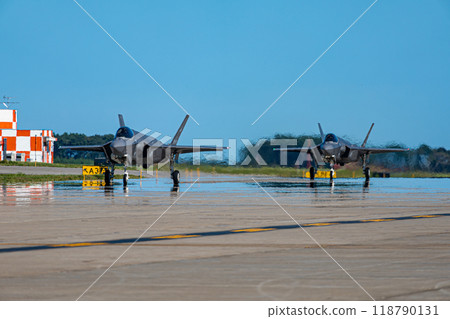 Stealth fighter F-35A running side by side on the runway 118790131