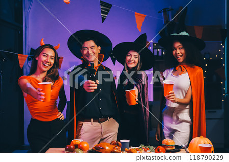 Joyful office Halloween party with coworkers in costumes, celebrating with drinks and laughter, fostering teamwork and festive spirit Joyful office Halloween party with coworkers in costumes, celebrating with drinks and laughter, fostering teamwork and festive spirit 118790229