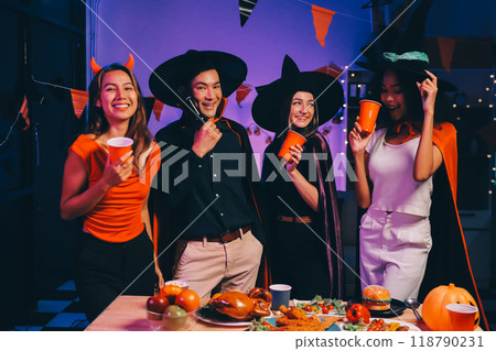 Joyful office Halloween party with coworkers in costumes, celebrating with drinks and laughter, fostering teamwork and festive spirit 118790231