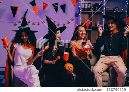 Joyful office Halloween party with coworkers in costumes, celebrating with drinks and laughter, fostering teamwork and festive spirit Joyful office Halloween party with coworkers in costumes, celebrating with drinks and laughter, fostering teamwork and festive spirit 118790239