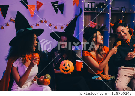 Joyful office Halloween party with coworkers in costumes, celebrating with drinks and laughter, fostering teamwork and festive spirit 118790243