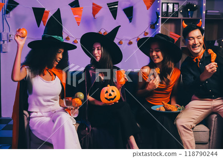 Joyful office Halloween party with coworkers in costumes, celebrating with drinks and laughter, fostering teamwork and festive spirit 118790244