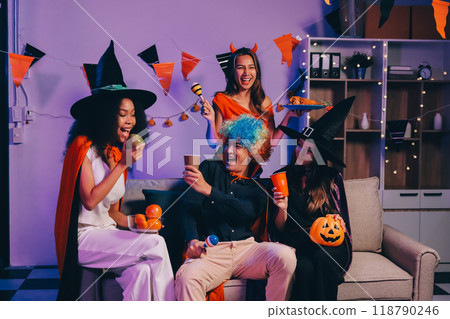 Joyful office Halloween party with coworkers in costumes, celebrating with drinks and laughter, fostering teamwork and festive spirit 118790246