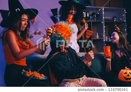 Joyful office Halloween party with coworkers in costumes, celebrating with drinks and laughter, fostering teamwork and festive spirit 118790261