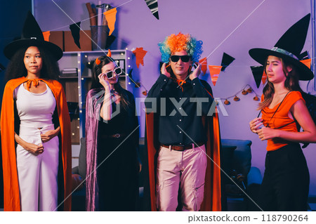Joyful office Halloween party with coworkers in costumes, celebrating with drinks and laughter, fostering teamwork and festive spirit 118790264