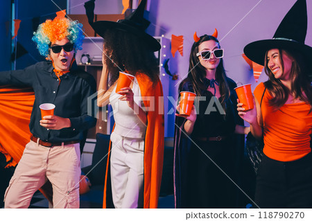 Joyful office Halloween party with coworkers in costumes, celebrating with drinks and laughter, fostering teamwork and festive spirit 118790270