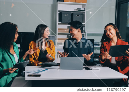 Young corporate employees sitting in office looking at laptop screen reading good news excited happy team diverse people celebrating victory win command success excellent result professional teamwork 118790297