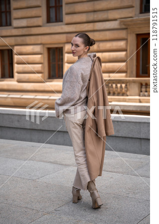 Young beautiful woman wearing coat walking in the city centre of Prague, Europe Young beautiful woman wearing coat walking in the city centre of Prague, Europe 118791515