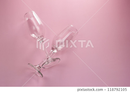 Two empty champagne glasses on a pink background, top view, copy space, flat lay Two empty champagne glasses on a pink background, top view, copy space, flat lay 118792105
