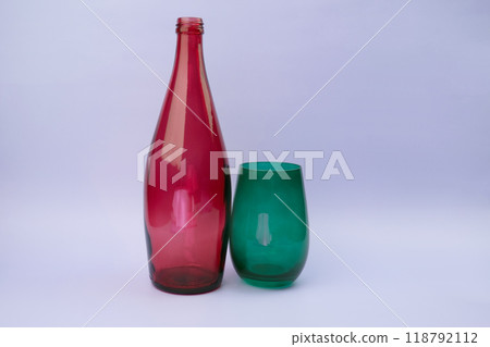 Colorful glass bottle and empty glass background 118792112