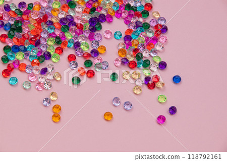Multicolored tiny faceted crystals on a pink background, beautiful colorful texture Multicolored tiny faceted crystals on a pink background, beautiful colorful texture 118792161
