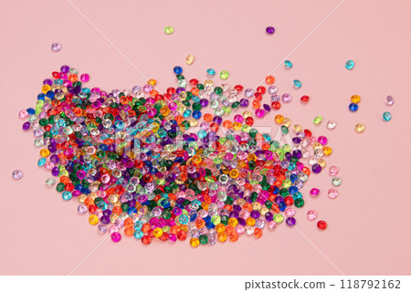 Multicolored tiny faceted crystals on a pink background, beautiful colorful texture Multicolored tiny faceted crystals on a pink background, beautiful colorful texture 118792162