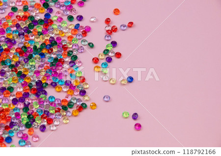 Multicolored tiny faceted crystals on a pink background, beautiful colorful texture 118792166