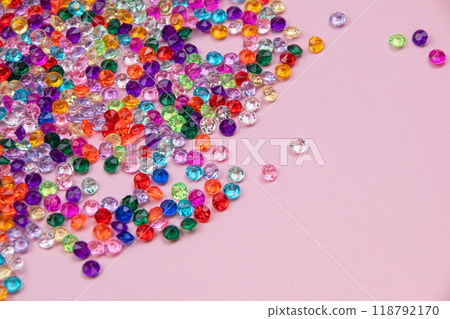 Multicolored tiny faceted crystals on a pink background, beautiful colorful texture 118792170