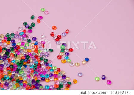 Multicolored tiny faceted crystals on a pink background, beautiful colorful texture 118792171