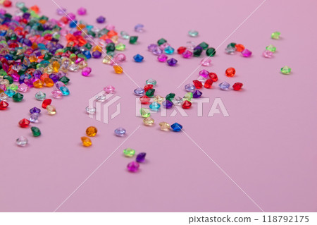Multicolored tiny faceted crystals on a pink background, beautiful colorful texture Multicolored tiny faceted crystals on a pink background, beautiful colorful texture 118792175