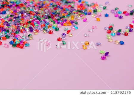 Multicolored tiny faceted crystals on a pink background, beautiful colorful texture 118792176