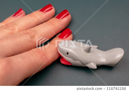 Shark bites a woman's hand with red nails, shark attack on human Shark bites a woman's hand with red nails, shark attack on human 118792288