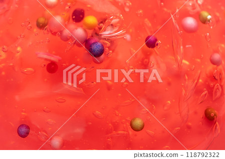 Colorful gel texture, clear skincare cream with bubbles and decorative figurines background, transparent beauty serum, colored cosmetic product close up 118792322