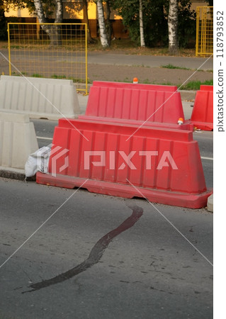 Red, white plastic safety barriers along roads. Ensuring road safety with visible barriers Red, white plastic safety barriers along roads. Ensuring road safety with visible barriers 118793852