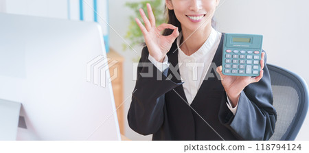 Business woman working with a calculator Business woman working with a calculator 118794124