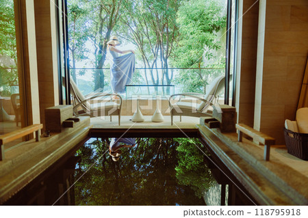 Woman enjoying a hot spring resort Woman enjoying a hot spring resort 118795918