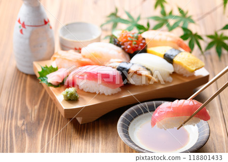 Dip sushi in soy sauce 118801433