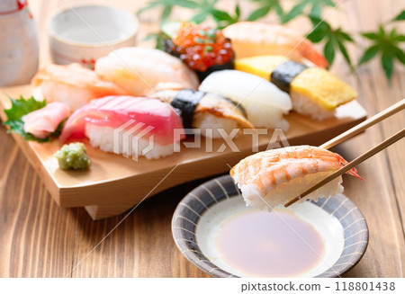Dip sushi in soy sauce 118801438