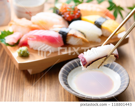 Dip sushi in soy sauce 118801443
