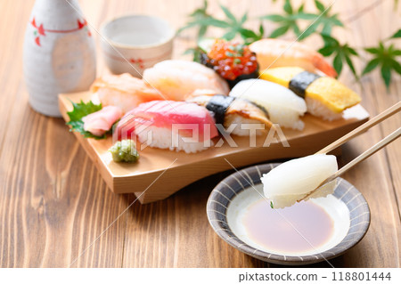 Dip sushi in soy sauce Dip sushi in soy sauce 118801444