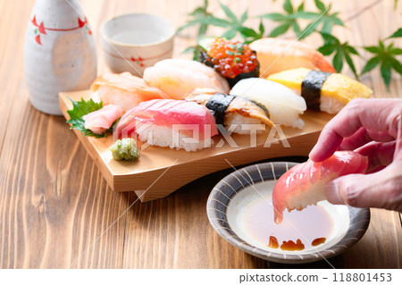 Dip sushi in soy sauce 118801453