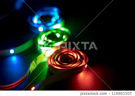 A stack of LED lights on coiled flexible lighting strips, various colors A stack of LED lights on coiled flexible lighting strips, various colors 118801507