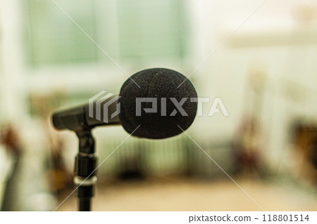 Black colored microphone on stand in blurry room 118801514