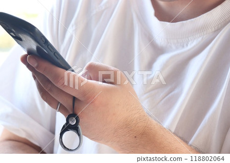 A man operating a smartphone A man operating a smartphone 118802064