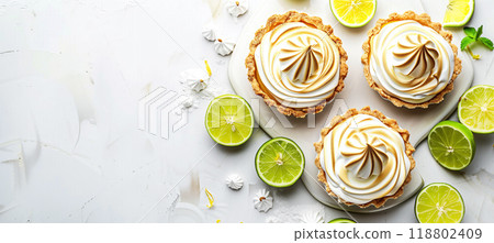 Delicious key lime pie and lemon meringue tart on pristine white surface 118802409
