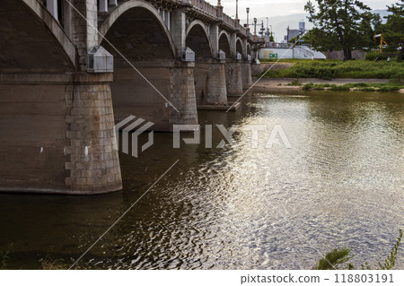 A concrete bridge and a calm river 118803191