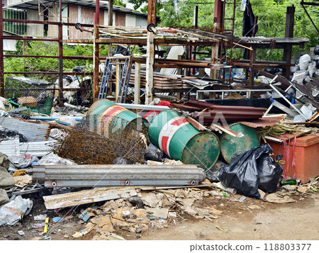 A pile of garbage with a bucket, rope, bottles, and other items at a landfill A pile of garbage with a bucket, rope, bottles, and other items at a landfill 118803377
