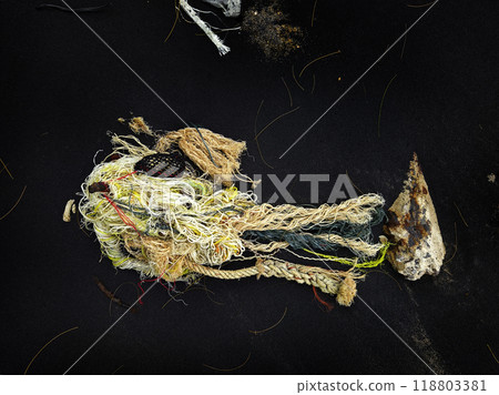 There is a pile of tightly wound rope and colorful yarn on a black surface There is a pile of tightly wound rope and colorful yarn on a black surface 118803381
