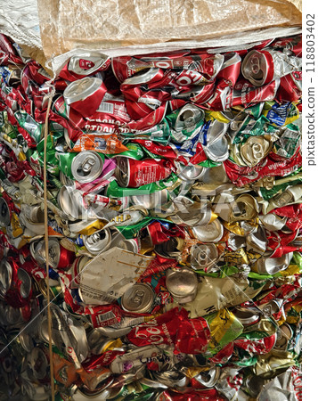 There is a large pile of crushed aluminum cans stacked on top of each other at the landfill. 118803402