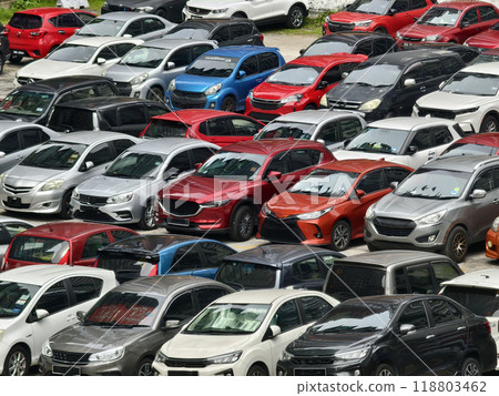 There are a great number of cars parked in a large parking lot 118803462