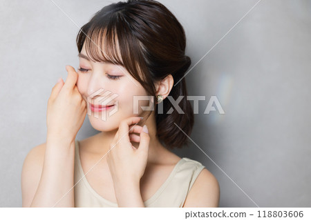 一位年輕女子感到皮膚濕潤 一位年輕女子感到皮膚濕潤 118803606