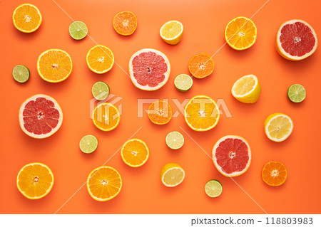 Freshly cut slices citrus fruits on an orange background. Freshly cut slices citrus fruits on an orange background. 118803983