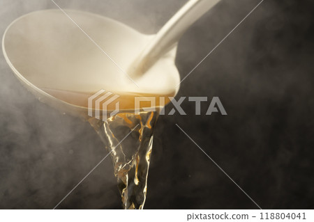 Dashi: Scoop up the warm dashi with a ladle. 118804041