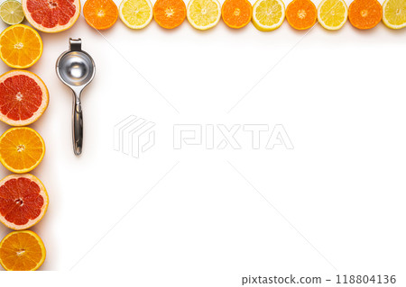 Fresh sliced and halved citrus fruits and a lemon squeezer of metal on a white background. Fresh sliced and halved citrus fruits and a lemon squeezer of metal on a white background. 118804136