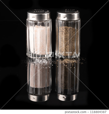 Salt and pepper shaker isolated on black background Salt and pepper shaker isolated on black background 118804387