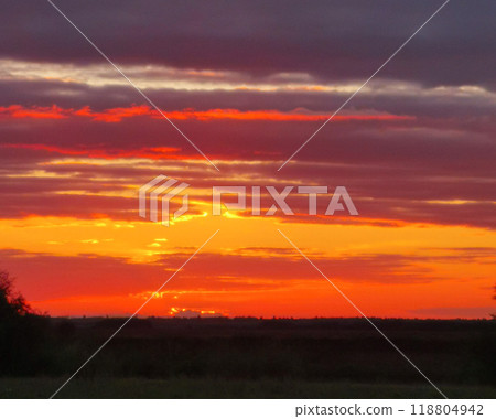 The sky is orange and the sun is setting The sky is orange and the sun is setting 118804942