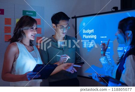 team of financial discussion budget planning, analyzing digital financial data and strategy in a modern office at night team of financial discussion budget planning, analyzing digital financial data and strategy in a modern office at night 118805077