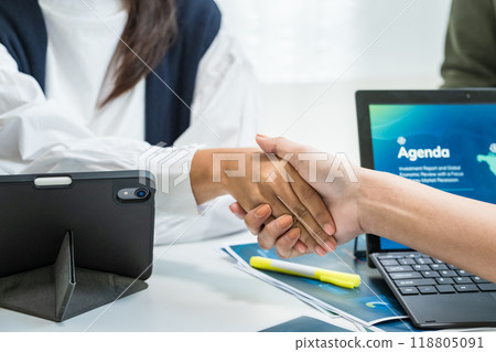 Close up financial officer hand shake deal with business in a meeting room in office Close up financial officer hand shake deal with business in a meeting room in office 118805091