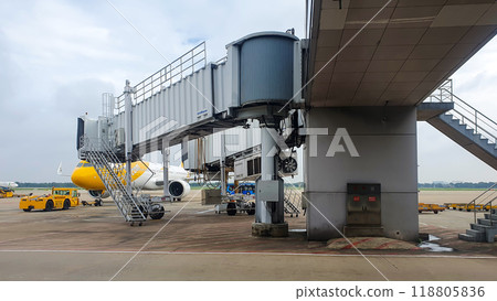 Commercial Airplane Connecting To Jet Bridge For Passenger Boarding At Airport. Commercial Airplane Connecting To Jet Bridge For Passenger Boarding At Airport. 118805836
