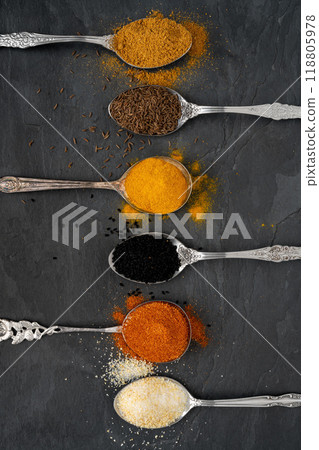 Various spices on tablespoons on a slate plate Various spices on tablespoons on a slate plate 118805978